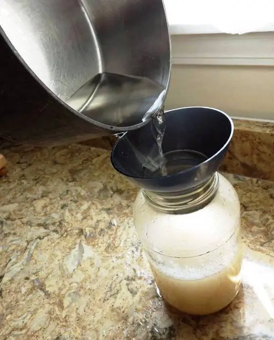 WATER POURING INTO JAR