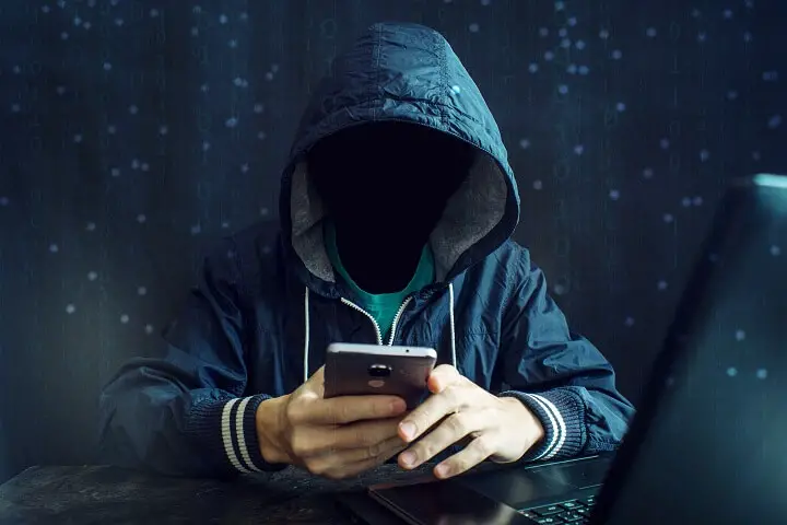 Anonymous Hacker Using Smartphone
