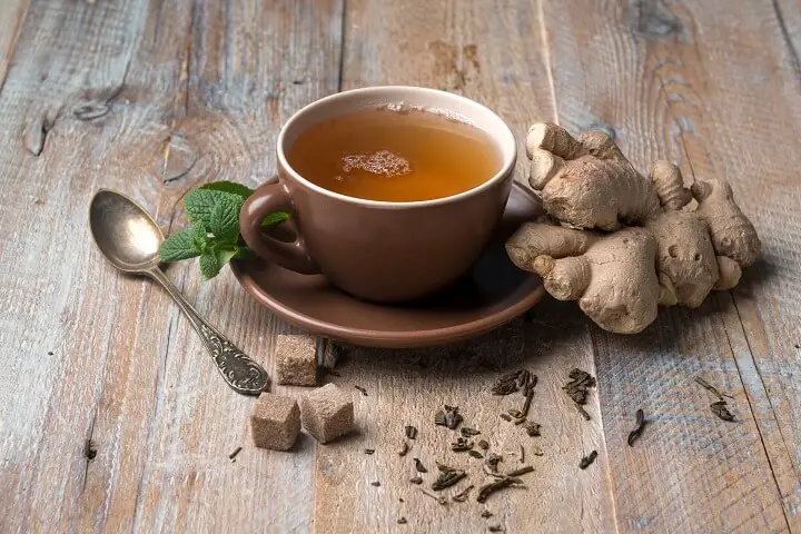 Cup Of Ginger Tea Next To Ginger Root