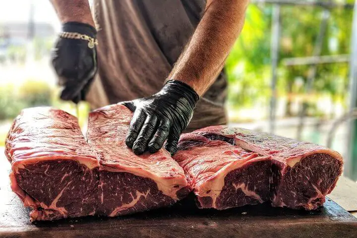 Cutting Meat In Butcher Shop