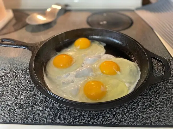 Eggs Cooking in Cast Iron Skillet
