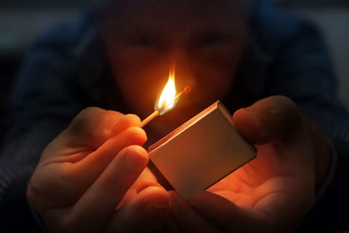 Man Burning A Match