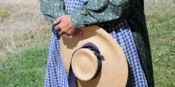 Pioneer Woman Holding Hat