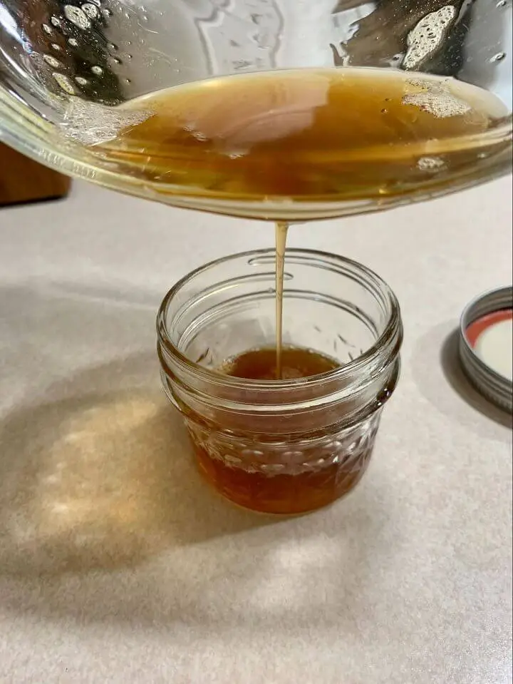 Pouring Ghee Into Mason Jar