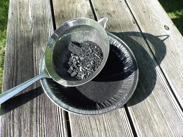 Screening the Charcoal Through a Strainer