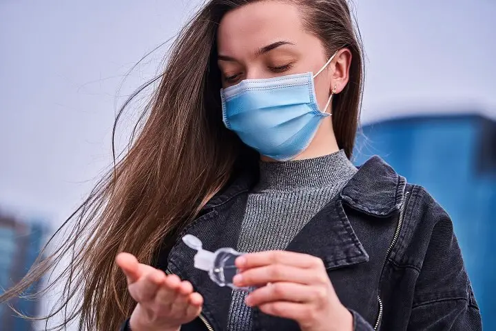 Woman Using Hand Sanitizer